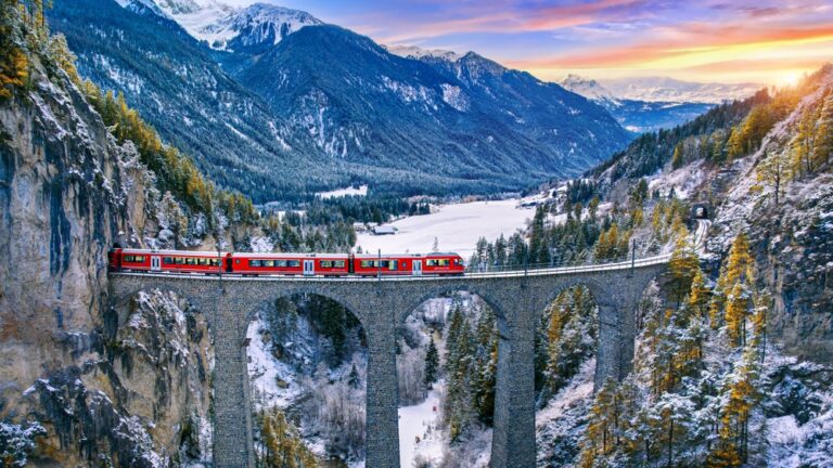 Aerial,View,Of,Train,Passing,Through,Famous,Mountain,In,Filisur,