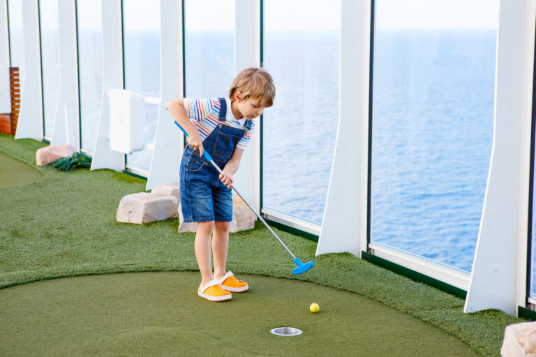 Little,Kid,Boy,Playing,Mini,Golf,On,A,Cruise,Liner